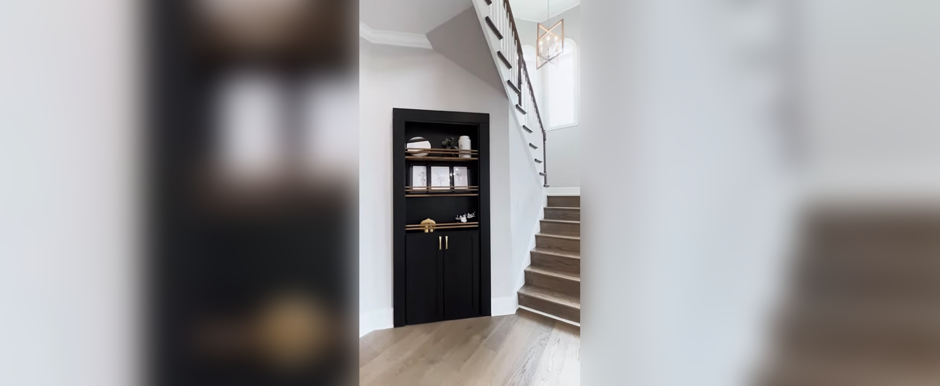 A black cabinet in the middle of stairs.