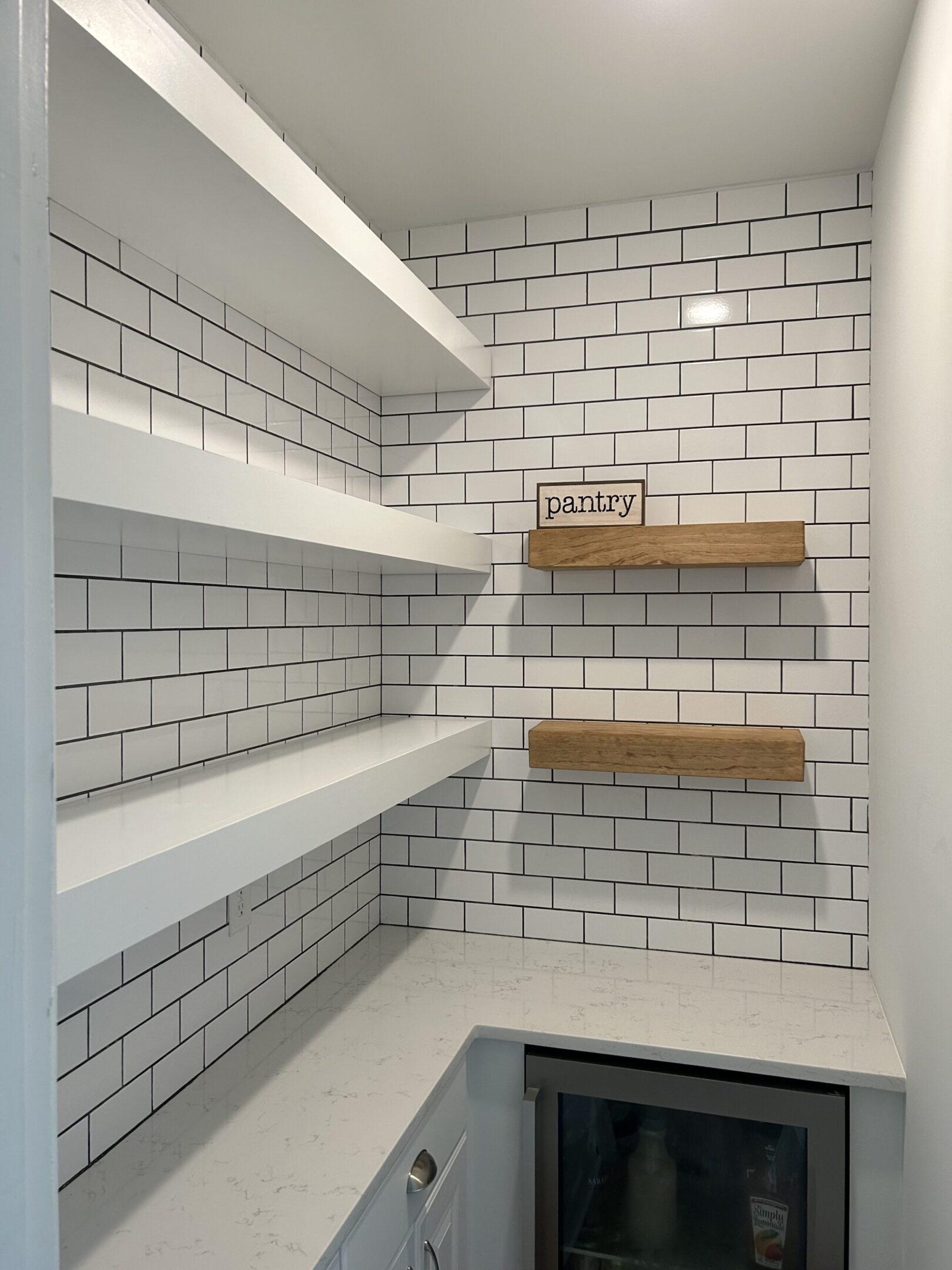 A white brick wall with shelves in it