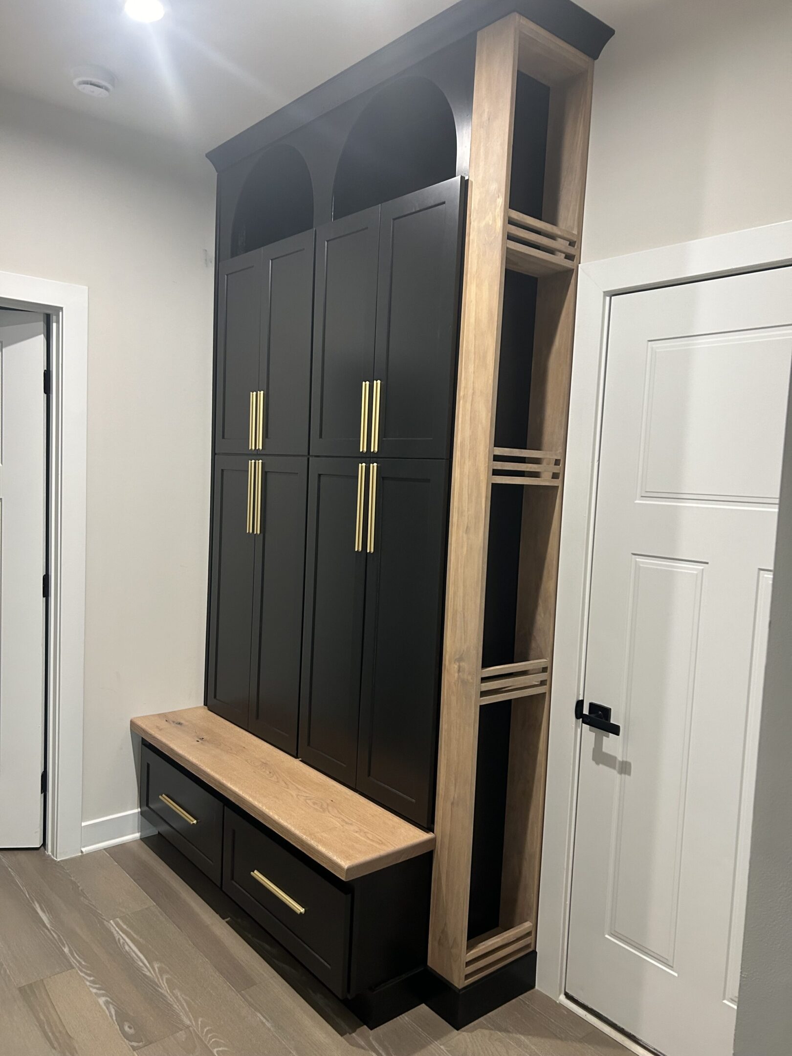 A black and brown cabinet with gold handles