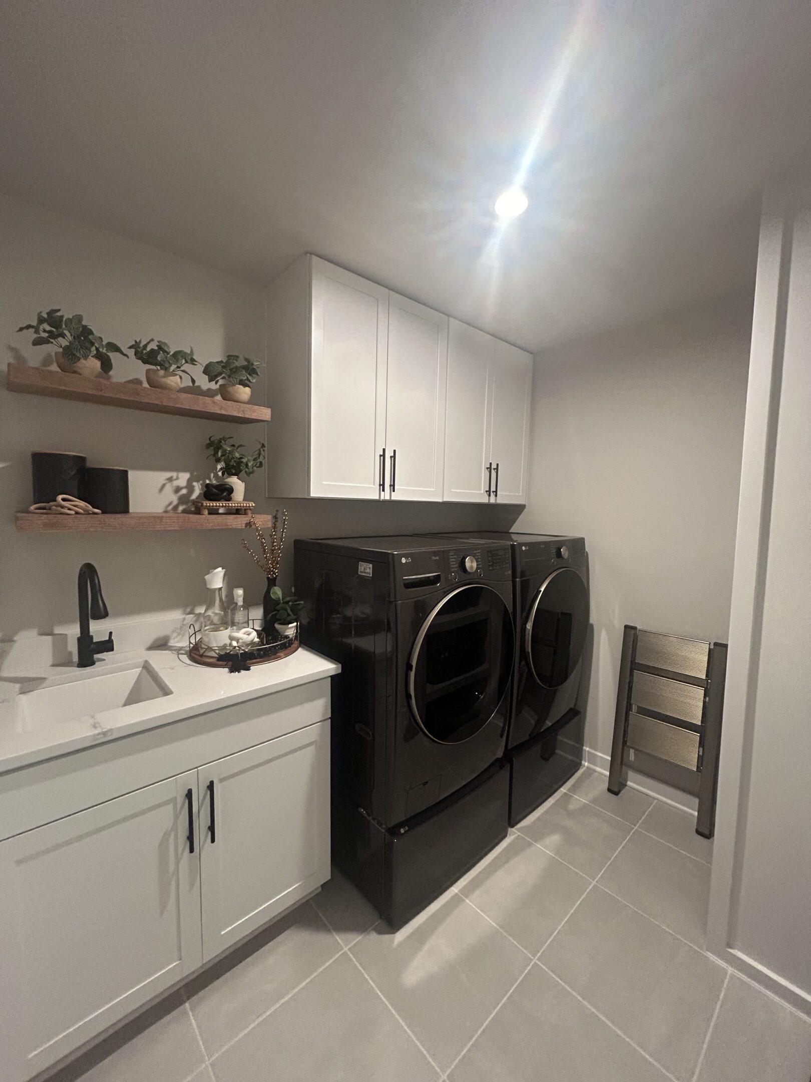 A black washer and dryer in a room.