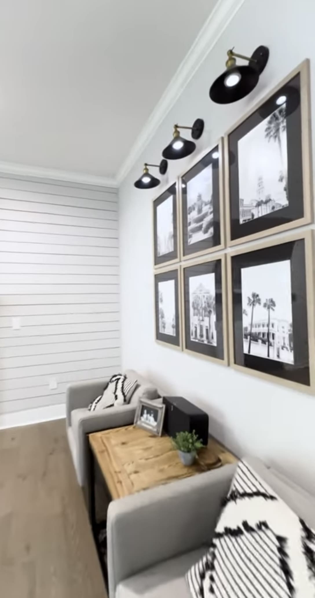 A living room with several pictures on the wall.