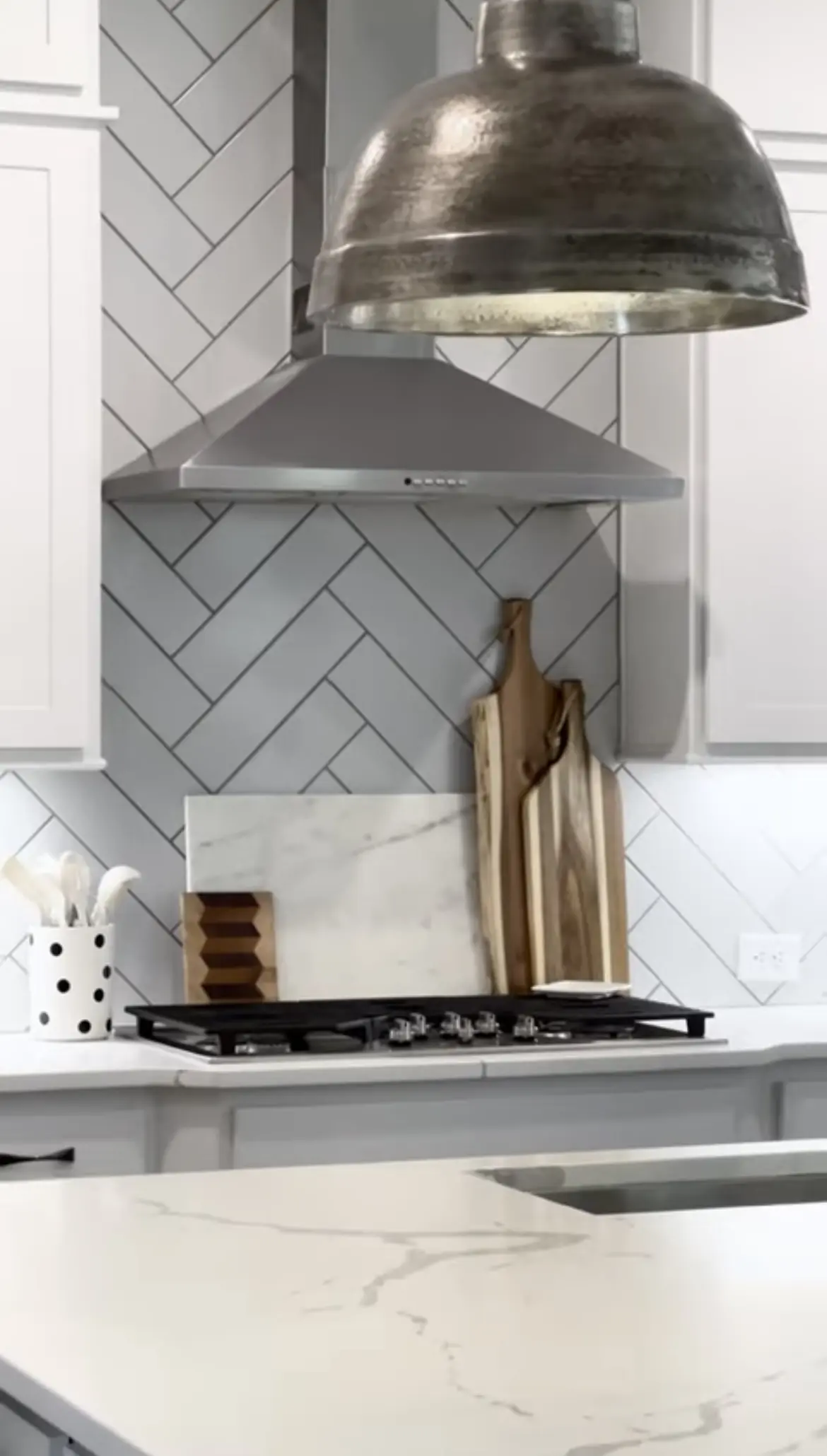 A kitchen with white cabinets and a stove