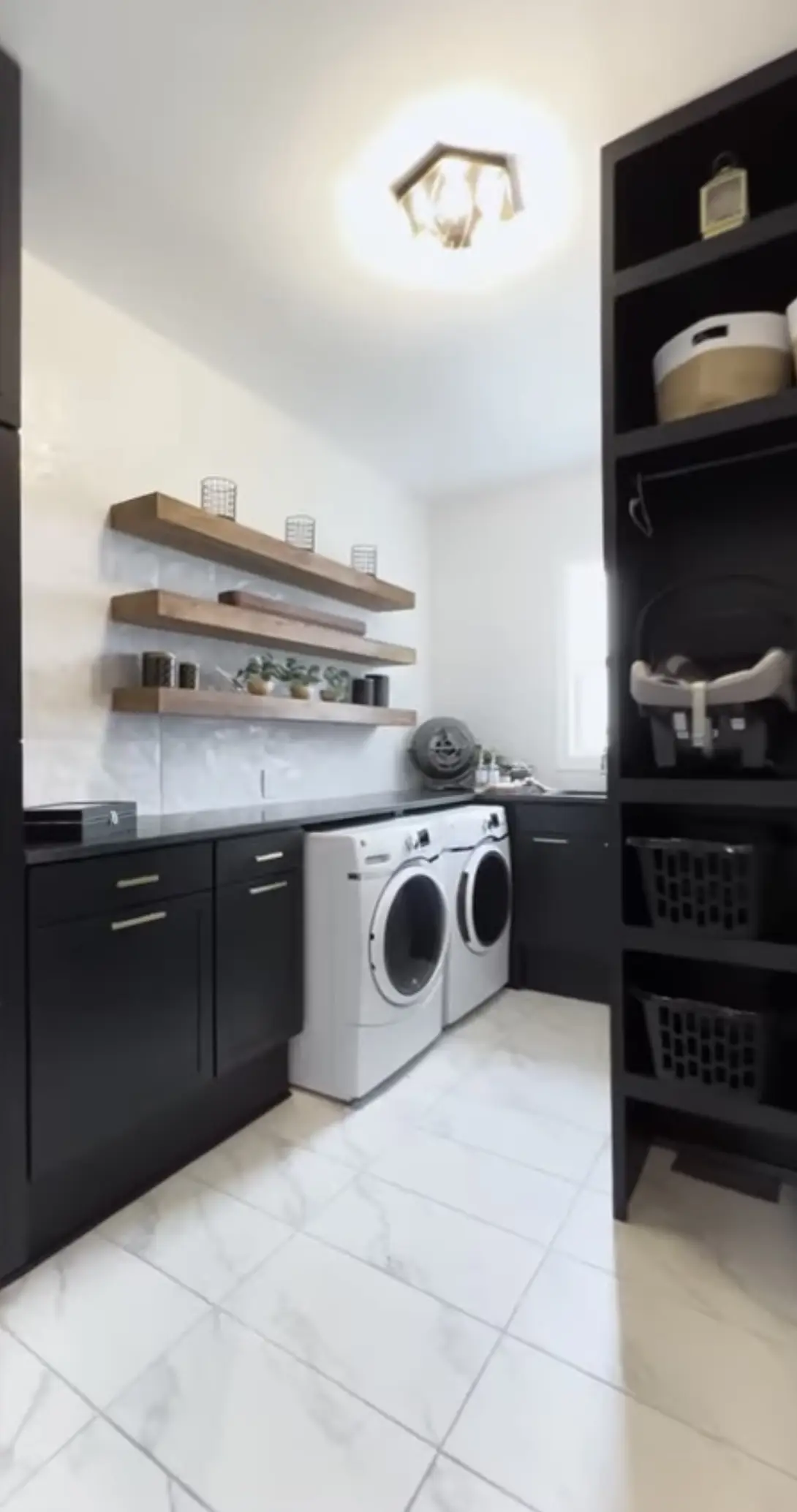 A black and white laundry room with shelves