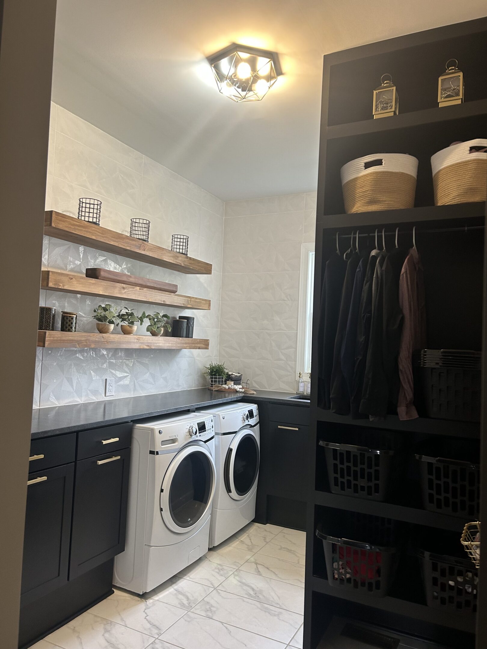 A room with two white washer and dryer.