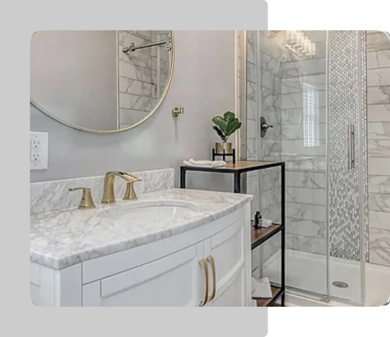 A bathroom with marble counter tops and white cabinets.